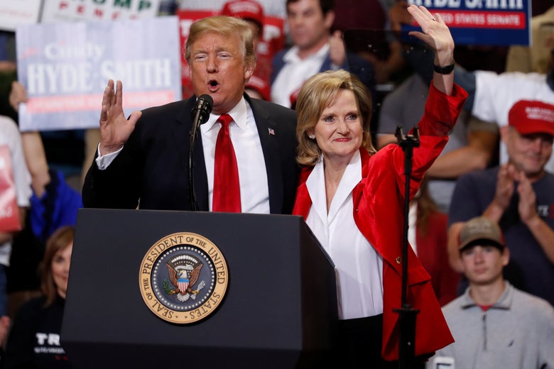 Donald Trump and Sen Cindy Hyde-Smith speak to supporters during a rally in Biloxi, Mississippi, on November 26, 2018.